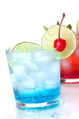 Two cocktails with lime slice and maraschino
