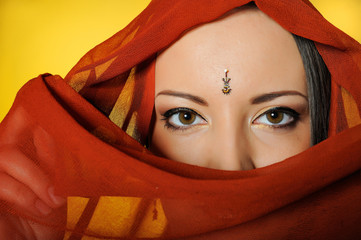 Young beautiful woman eyes in indian traditional style