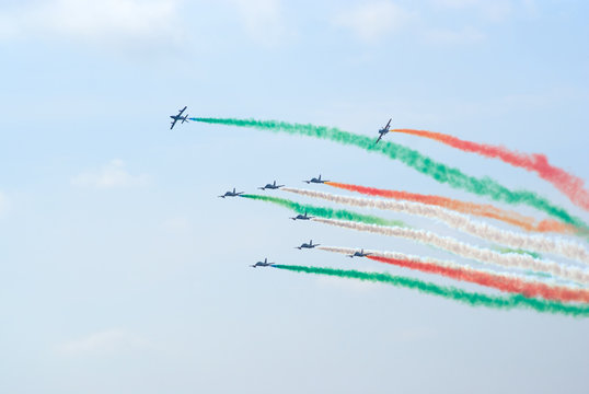Group of Aermacchi jets with colored smoke trails
