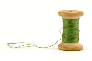 green thread spool , isolated on white background