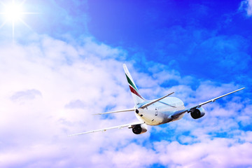 Airplane at fly on the sky with clouds