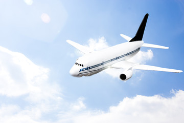 Fototapeta na wymiar An airplane flying in the blue sky