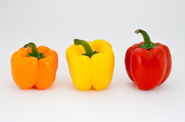 Amber, red and yellow pepper isolated on white