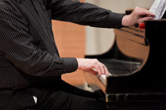 Hands of piano player during performance