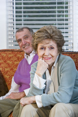Loving senior couple sitting together on couch