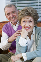 Loving senior couple sitting together on couch