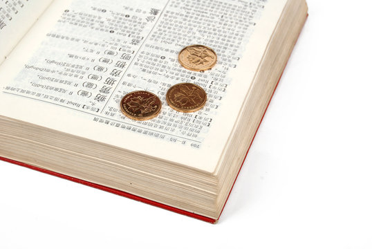 gold coin on book