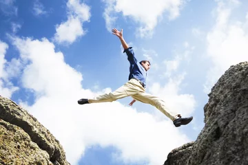 Foto op Plexiglas Businessman jumping over the mountains, business concept © clarusvisus