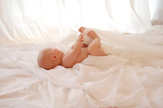 Cute baby looking out of a window_ indoor