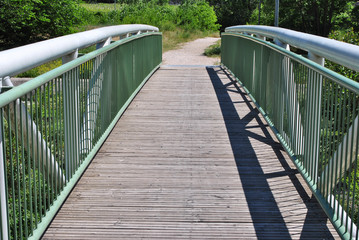 white wooden bridge in park