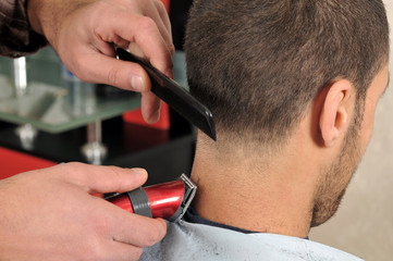Barber cutting hair with clipper