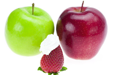 apples and strawberries with whipped cream isolated on white