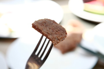cutting a steak with knife and fork .