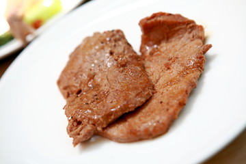 a steak with in a white plate