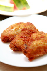 Plate of crispy, delicious fried chicken .