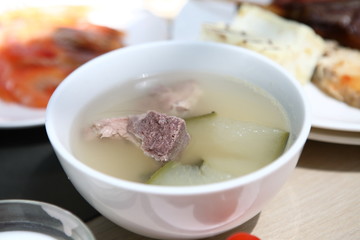 bone soup in a white bowl on table