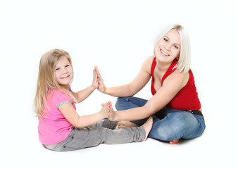 happy mother and daughter playing over white