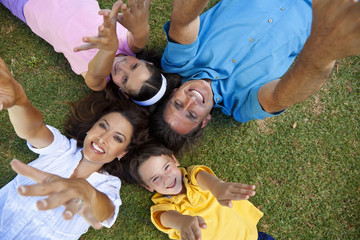 Fototapeta premium Father Mother Son and Daughter Family Laying Down Hands Up