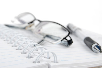 notebook & pen with glasses