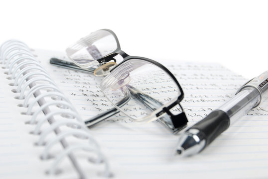 notebook & pen with glasses