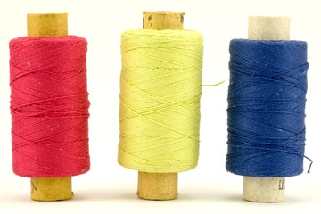 three colorful thread spools,isolated on white background