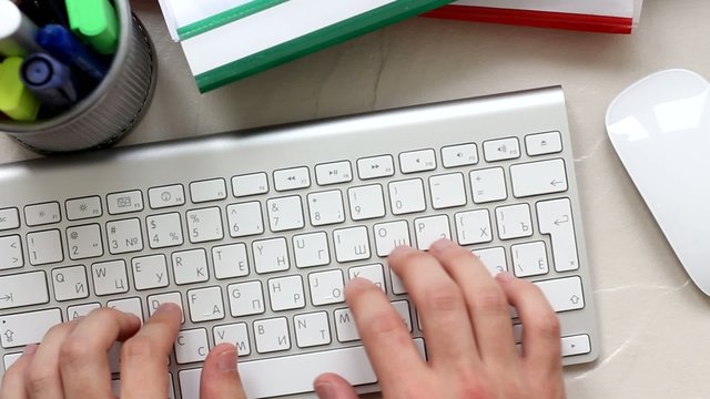 Busy typing on a white  keyboard