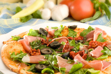 Pizza with ham, olives and capsicum pepper