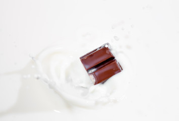 Chocolate candy splashing into milk