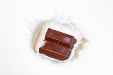 Chocolate candy splashing into milk