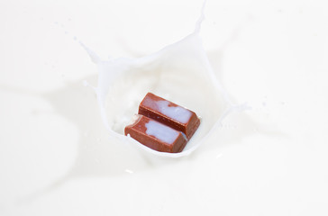 Chocolate candy splashing into milk
