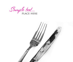 a Knife and fork stacked up on a pure white background