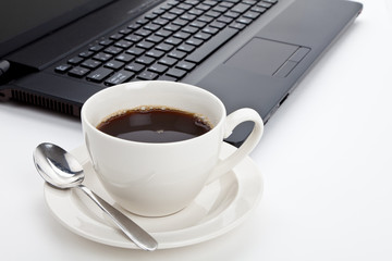 Coffee cup and computer