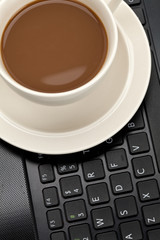 Coffee cup and computer