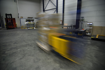 Fork lift driving fast with cargo