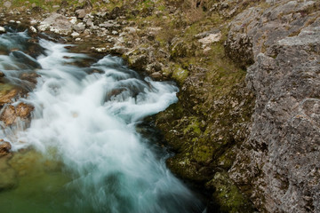 Waterfall with stones in wild nature
