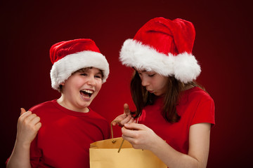 Kids as Santa Claus - red background