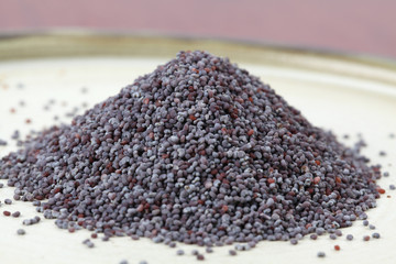 Heap of poppy seeds on a plate