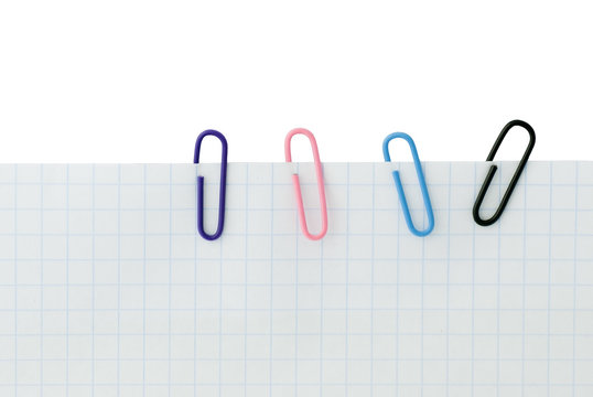 Close up of four paper clips holding a blank paper sheet