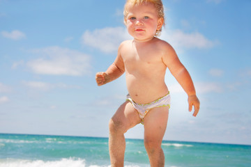 close up of toddler on sea and sky background