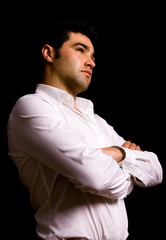 Pensive young casual man on black background