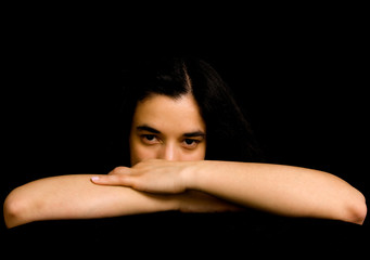 Naklejka premium young beautiful brunette portrait against black background