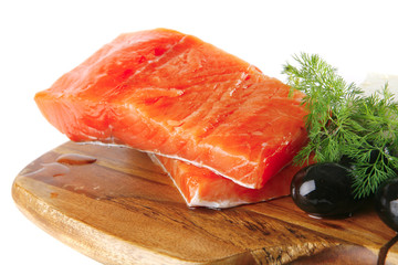 pink smoked salmon on wooden plate with white cheese