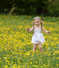 Little girl on grass in flower.