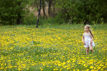 Little girl on grass in flower.