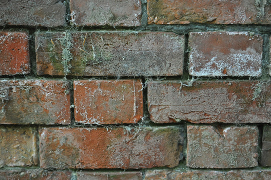 Old and worn red brick wall