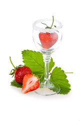 Strawberry fruits with green leaves in glass