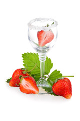 Strawberry fruits with green leaves in glass