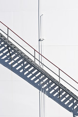 white tanks in tank farm with staircase