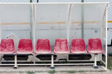 Fototapeta premium Old and damaged bench on a public football pitch