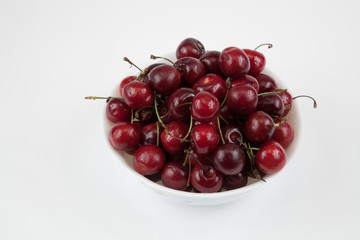 A bowl of fresh cherry isolated on white